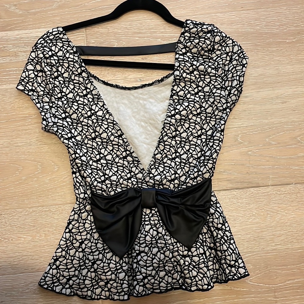 Peplum top with black bow on back